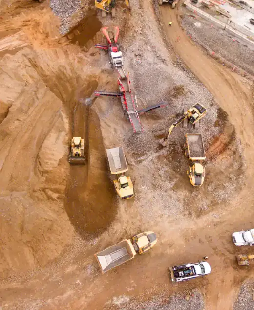 Aerial view of an earthworks site with haul trucks and excavators